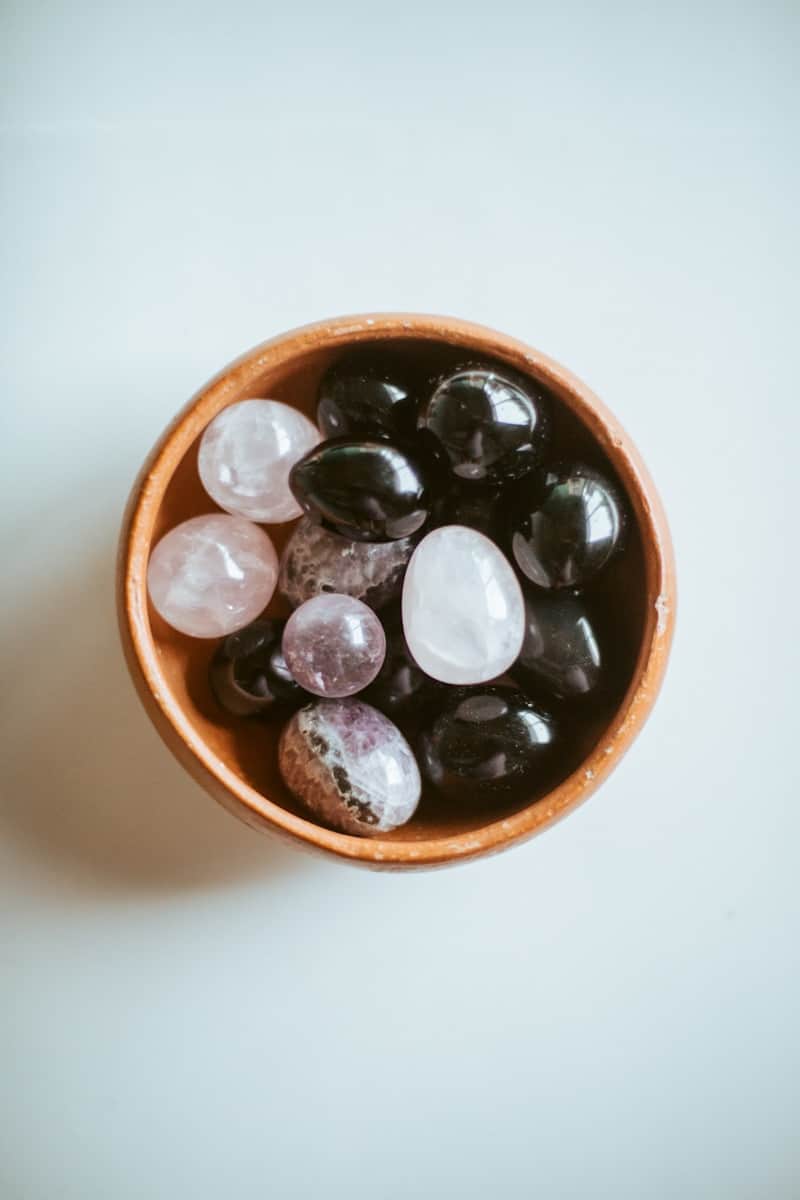 a bowl filled with lots of rocks on top of a table