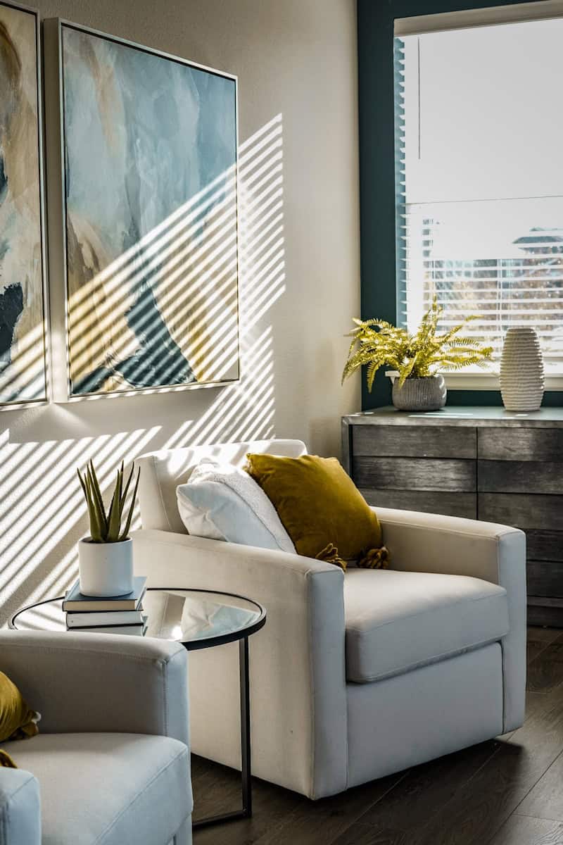 Photo by Afif Ramdhasuma a living room filled with furniture and a painting on the wall